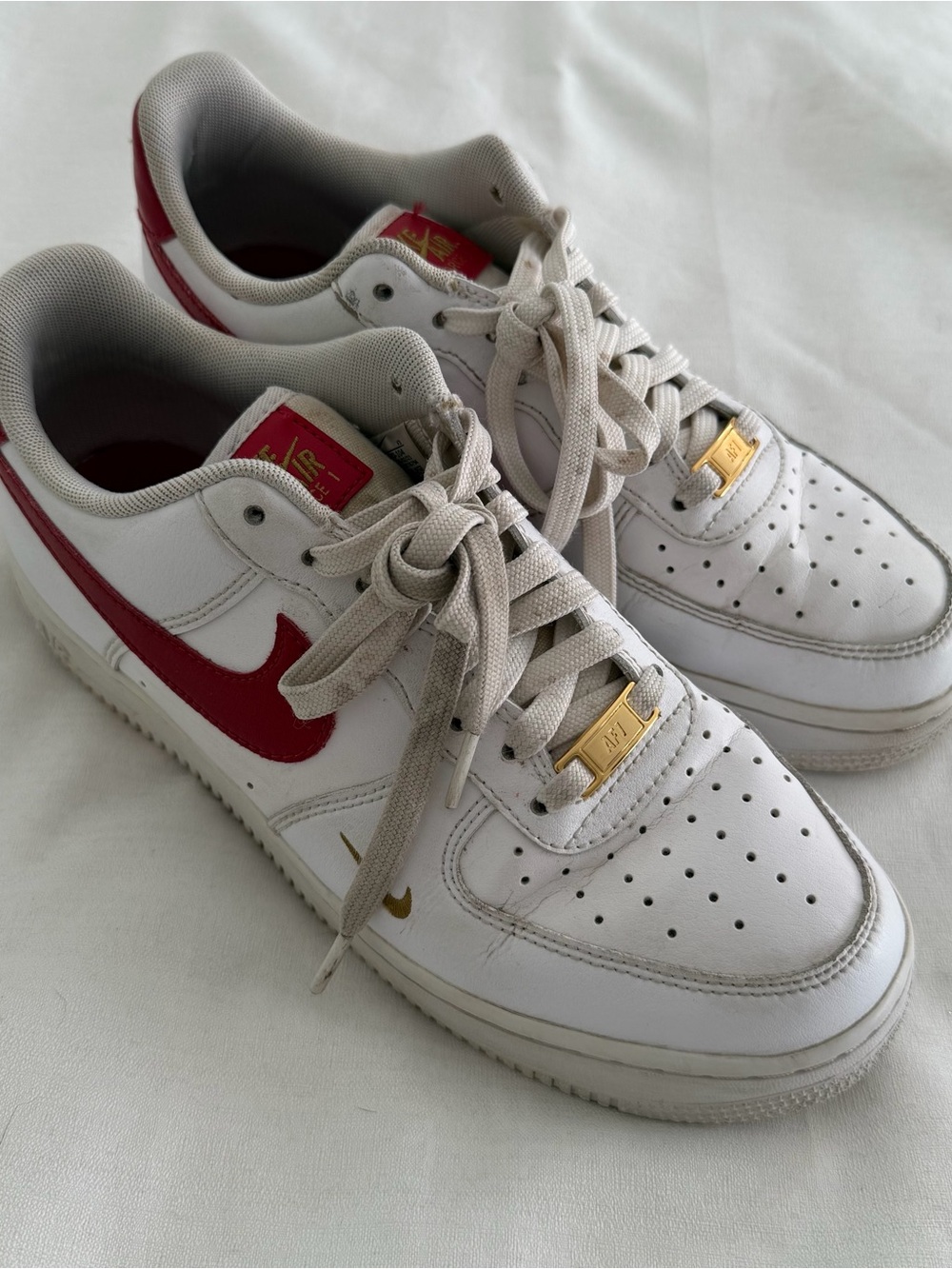 Nike Air Force 1s in white and gym red with gold accents size women’s 9.5